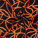 Ottoman viscose crêpe spaghetti orange print black background