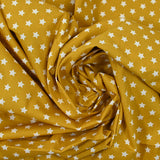 Cotton poplin printed stars mustard background