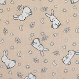 Piqué de coton imprimé jeune lapin fond beige