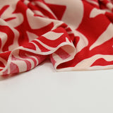 Polyester jersey printed forms of ecru flower red background