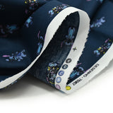 Popeline de coton imprimé Stitch fond bleu nuit