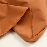 Lona de poliéster elástica naranja quemado