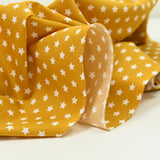 Cotton poplin printed stars mustard background