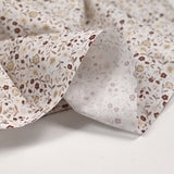 Coton imprimé ouragan floral marron fond blanc