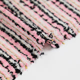 Tweed de polyester rayure doré, noir, blanc fond rose