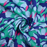 Satin de coton élasthanne fleurs bleu fond vert menthe
