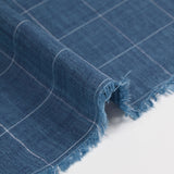 Woven cotton dyed white line check mottled blue background