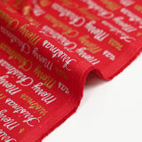 Popelina de algodón estampada con Feliz Navidad en dorado y plateado sobre fondo rojo