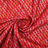 Popelina de algodón estampada con Feliz Navidad en dorado y plateado sobre fondo rojo