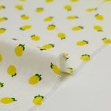 Jersey pointelle coton imprimé citron fond blanc cassé