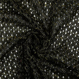 Dentelle polyester ajourée à entrelacs de lurex doré fond noir