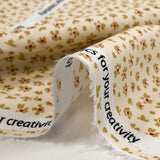 Cotton poplin printed with abstract flowers on an ecru background