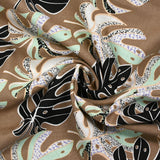 Lin viscose printed rain of monsteras brown background