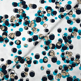 Satin de coton élasthanne dans les bulles turquoise fond blanc