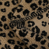 Fausse fourrure sherpa léopard noir fond marron