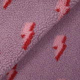 Fausse fourrure sherpa éclairs fond lilas