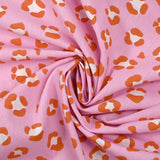 Algodón estampado leopardo fondo rosa naranja quemado