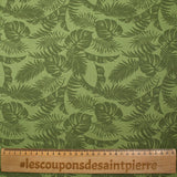 Coton imprimé envolée de feuilles fond vert