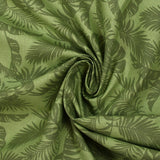 Coton imprimé envolée de feuilles fond vert