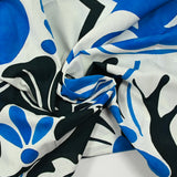 Cotton voile with blue and black arabesque print on white background