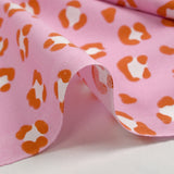 Algodón estampado leopardo fondo rosa naranja quemado