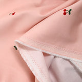 Velours de coton côtelé imprimé cerise fond rose