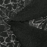 Lainage bouclette brodé esquisse florale fond noir