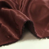 Satin lourd brodé et sequins patchwork fond bordeaux au mètre
