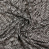 Viscose imprimée hypnose abstraite fond marron foncé