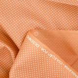 Coton imprimé pois 1mm fond terre de sienne