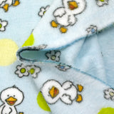 Fleet comforter printed with flowers and ducklings on a sky blue background