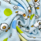 Fleet comforter printed with flowers and ducklings on a sky blue background
