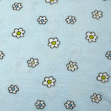 Fleet comforter printed with flowers and ducklings on a sky blue background