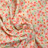 Viscose imprimée spirale de fleurs roses et orange fond écru