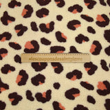 Faux leopard sherpa fur salmon and plum ecru background