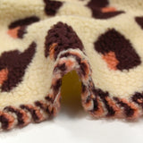Faux leopard sherpa fur salmon and plum ecru background