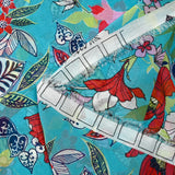 Mousseline imprimée fleurs exotiques rouge et blanc fond turquoise