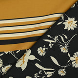 Twill de polyester satiné imprimé fleurs écrues et bordure ocre fond noir