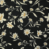 Twill de polyester satiné imprimé fleurs écrues et bordure ocre fond noir