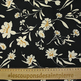 Twill de polyester satiné imprimé fleurs écrues et bordure ocre fond noir