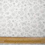 Piqué de coton imprimé papillons et fleurs fond blanc