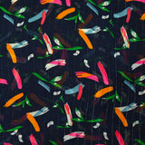 Gold striped muslin printed with fireworks on a navy background