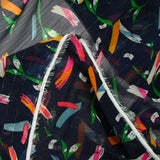 Gold striped muslin printed with fireworks on a navy background