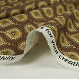 Coton imprimé goutte d'or fond marron