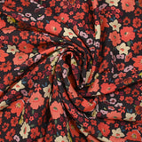 Crêpe polyester imprimé fleurs corail fond marron