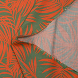 Viscose imprimée feuilles tropicales orange fond vert