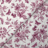 Viscose printed with purple flowers and butterflies on a white background