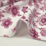 Viscose printed with purple flowers and butterflies on a white background