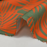Viscose imprimée feuilles tropicales orange fond vert