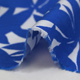Viscose printed with blue bamboo leaves on white background